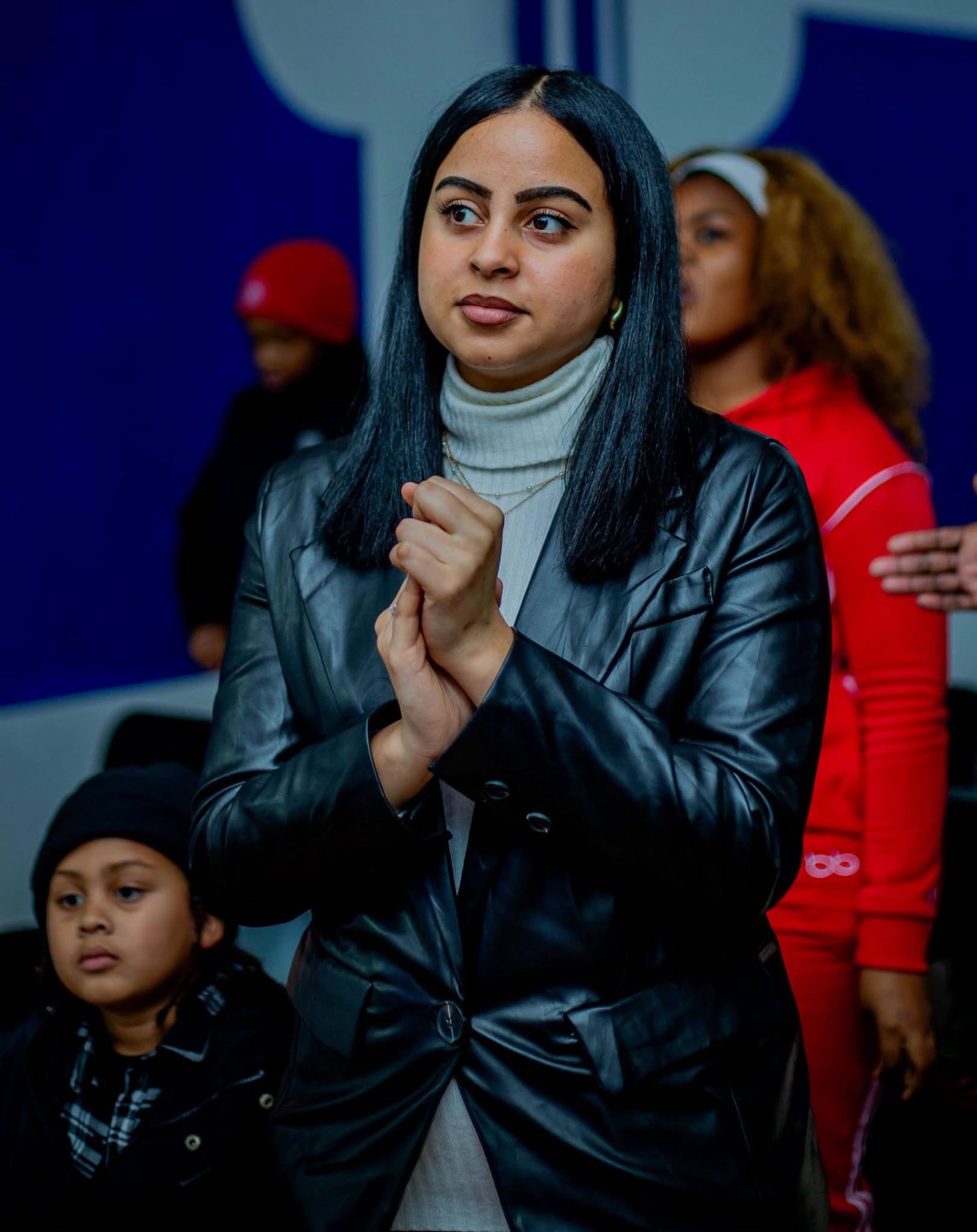 A young worshipper standing in prayer during a service