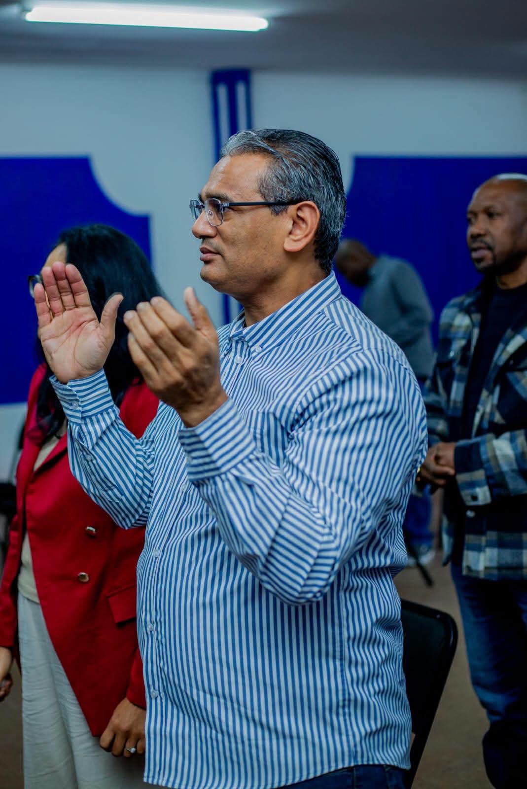 Members of the congregation in prayer during a service