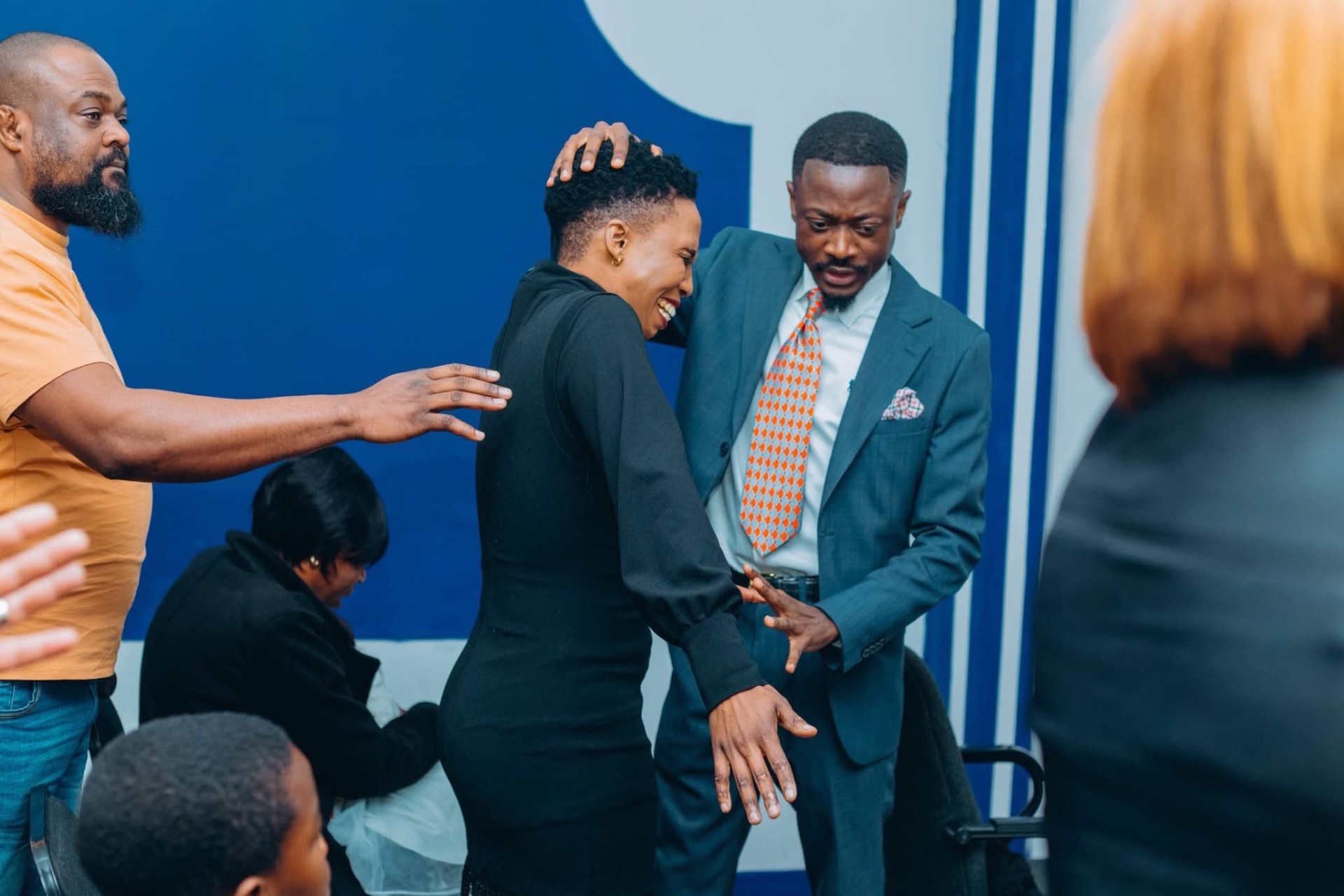 A minister praying over a member of the congregation during a time of impartation